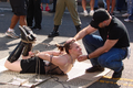 BDSM-Paar - Top and Bottom - Tied on Pavement at Folsom Street Fair 2006.png