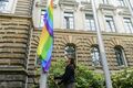 Katja Meier hisst eine Regenbogenfahne vor dem Justizministerium.jpg